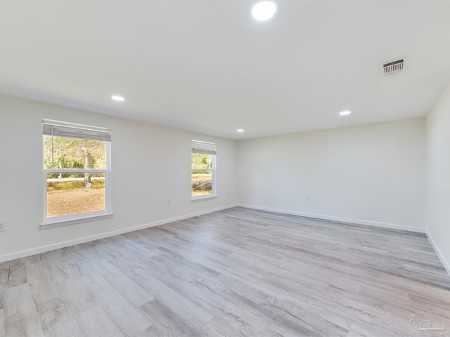 spare room featuring light hardwood / wood-style floors