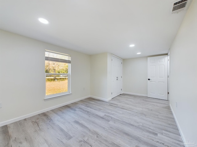 spare room featuring light wood-type flooring