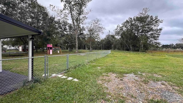 view of yard featuring a playground and a trampoline