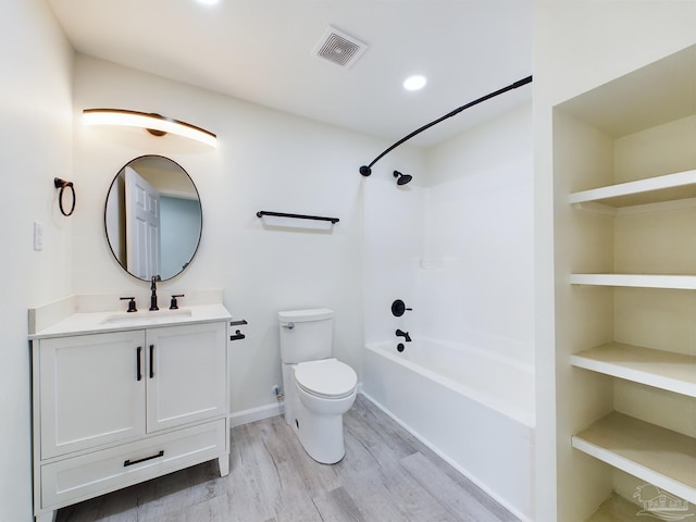 full bathroom with vanity, hardwood / wood-style flooring, toilet, and shower / bathtub combination