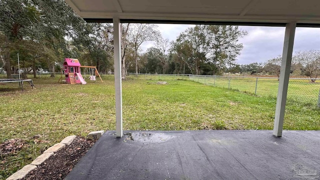 view of yard featuring a playground, a patio, and a trampoline