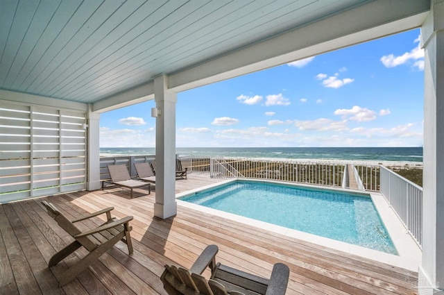 view of swimming pool featuring a beach view and a water view