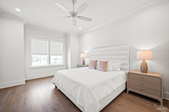 bedroom featuring ceiling fan, dark wood-type flooring, and ornamental molding