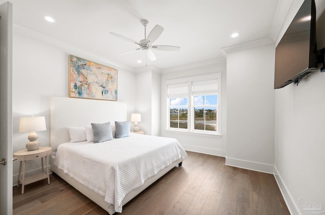 bedroom with ceiling fan, crown molding, and dark hardwood / wood-style flooring