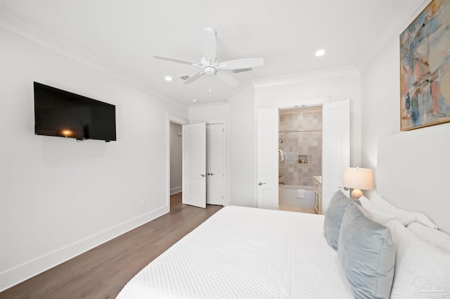 bedroom featuring ceiling fan, dark hardwood / wood-style flooring, ornamental molding, and ensuite bath