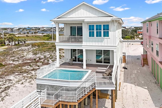 back of house featuring a balcony