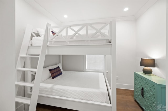 bedroom featuring dark hardwood / wood-style flooring and crown molding