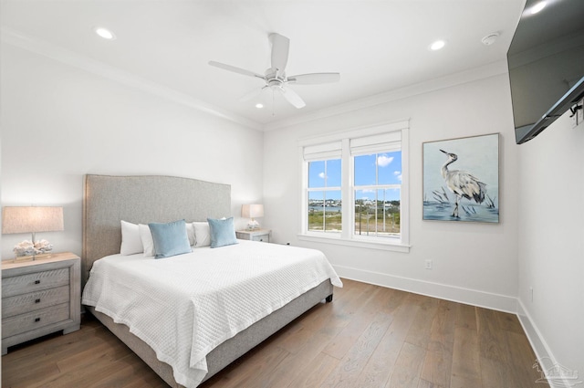 bedroom with ceiling fan, dark hardwood / wood-style flooring, and crown molding