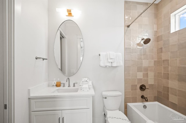 full bathroom with vanity, tiled shower / bath combo, and toilet