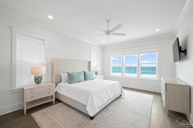 bedroom with ceiling fan, crown molding, and dark hardwood / wood-style floors