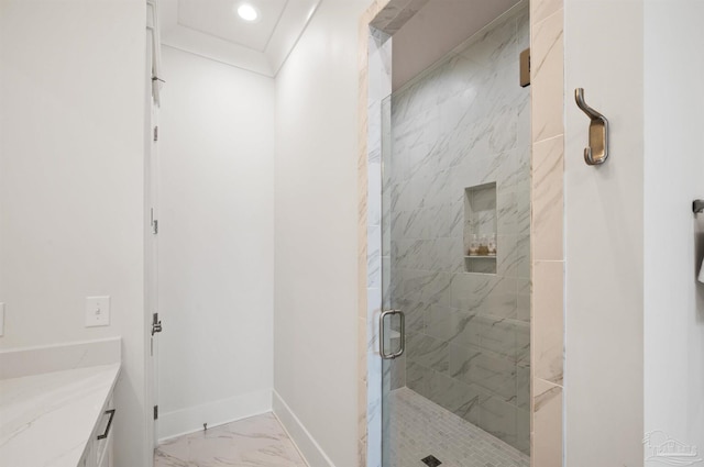 bathroom with ornamental molding, vanity, and a shower with shower door