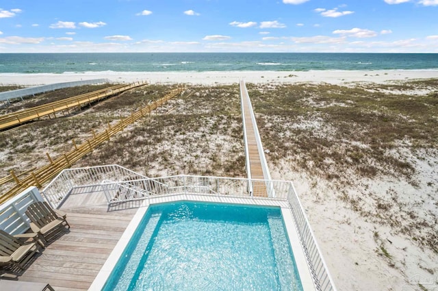 view of swimming pool featuring a beach view and a water view