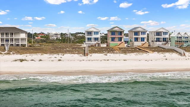 exterior space featuring a beach view and a water view