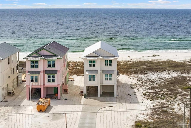 drone / aerial view featuring a beach view and a water view