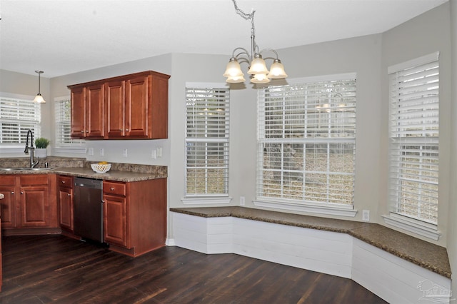 kitchen featuring reddish brown cabinets, dark wood-style flooring, a sink, an inviting chandelier, and stainless steel dishwasher