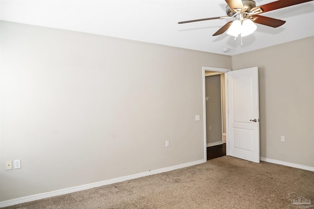 unfurnished room featuring carpet floors, baseboards, and a ceiling fan