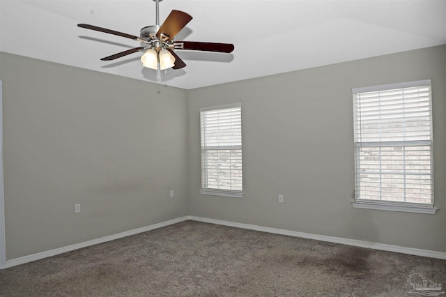 spare room featuring carpet floors, ceiling fan, and baseboards