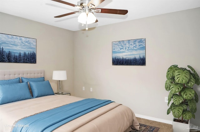 carpeted bedroom featuring radiator heating unit, a ceiling fan, and baseboards