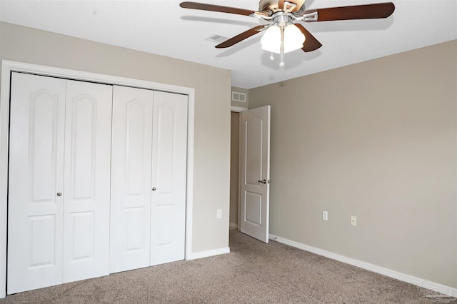 unfurnished bedroom with carpet floors, baseboards, visible vents, and a closet