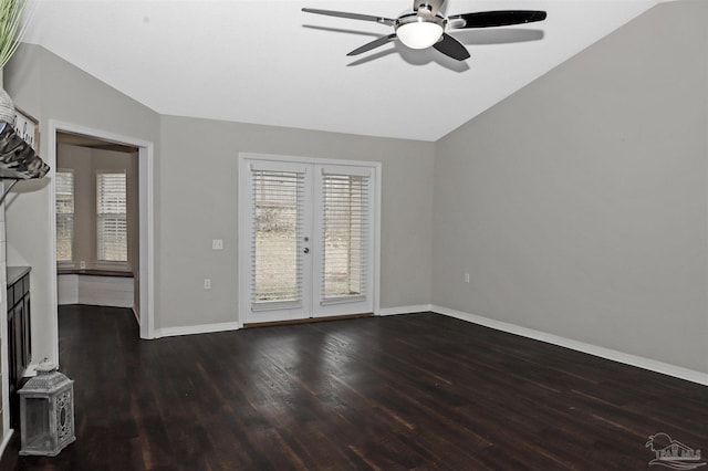 unfurnished living room with french doors, dark wood-type flooring, vaulted ceiling, ceiling fan, and baseboards