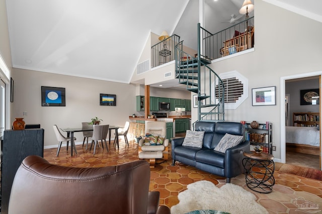 living room with stairs, high vaulted ceiling, visible vents, and baseboards