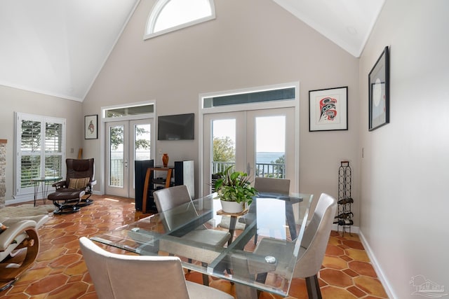 dining space with high vaulted ceiling, french doors, and baseboards