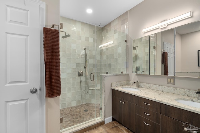 full bathroom with a stall shower, tile patterned flooring, and a sink