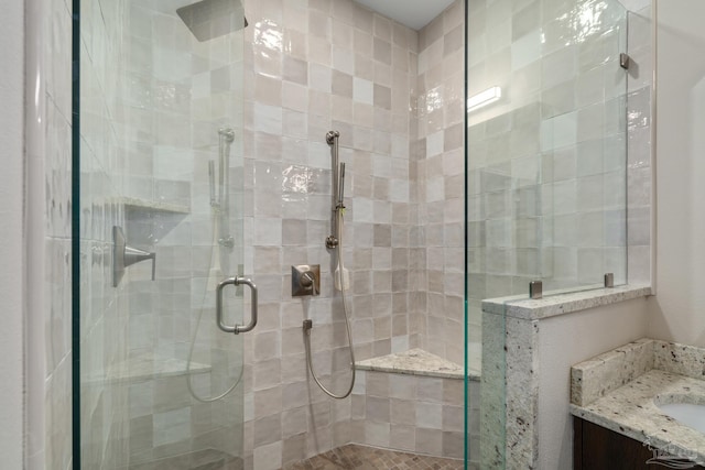 bathroom with a stall shower and vanity