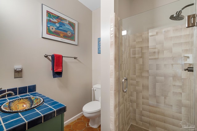 bathroom featuring baseboards, toilet, tile patterned flooring, vanity, and a shower stall