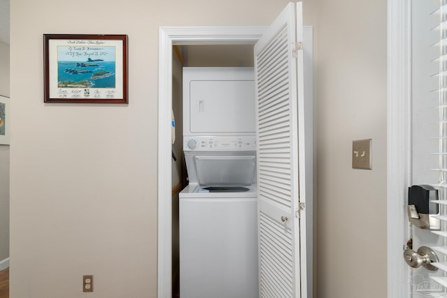 clothes washing area with laundry area and stacked washer / drying machine