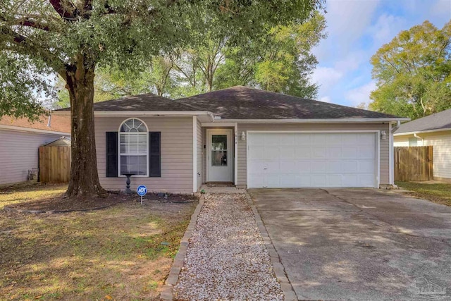 ranch-style house featuring a garage, concrete driveway, and fence