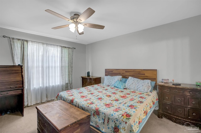 bedroom with a ceiling fan and light colored carpet