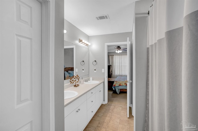 ensuite bathroom featuring double vanity, visible vents, a sink, and ensuite bathroom