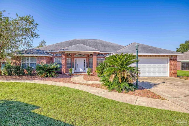 ranch-style house featuring a front yard and a garage