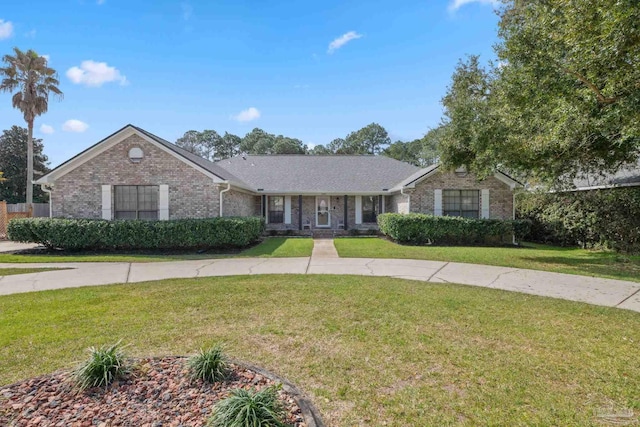 ranch-style house with a front yard and brick siding