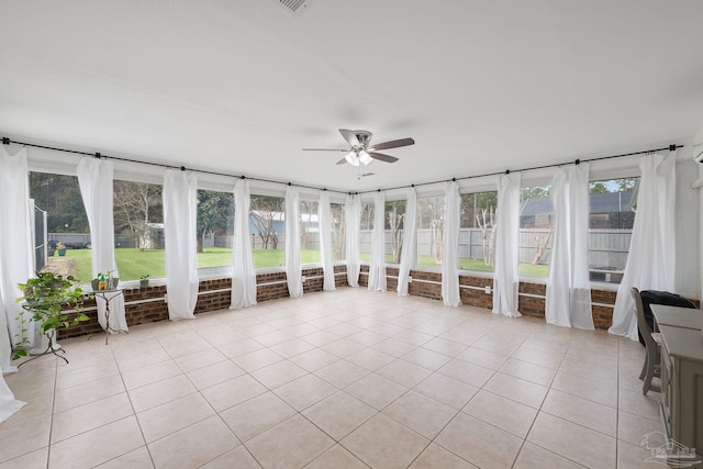 unfurnished sunroom featuring ceiling fan