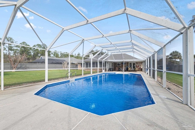 view of swimming pool featuring glass enclosure, fence, a lawn, a fenced in pool, and a patio area