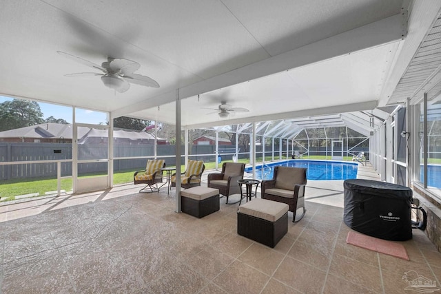 sunroom featuring a ceiling fan