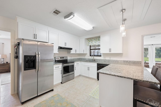 kitchen featuring under cabinet range hood, stainless steel appliances, a peninsula, a sink, and visible vents