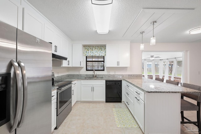 kitchen with appliances with stainless steel finishes, a kitchen breakfast bar, a peninsula, under cabinet range hood, and a sink