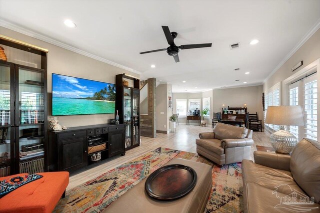 living room featuring visible vents, recessed lighting, crown molding, and light wood-style floors