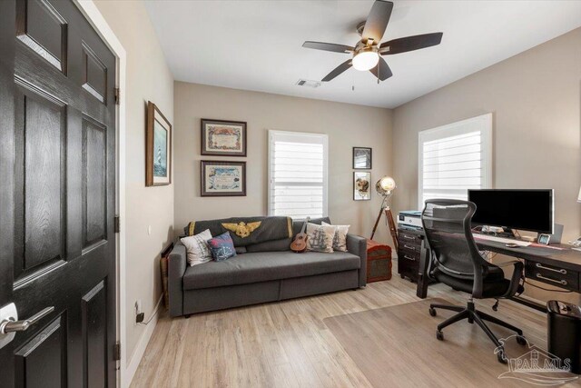 office with visible vents, ceiling fan, baseboards, and light wood-style floors