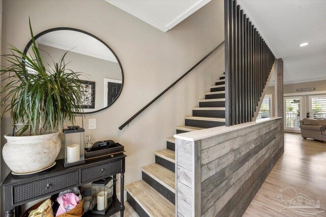 staircase featuring recessed lighting, french doors, wood finished floors, and ornamental molding