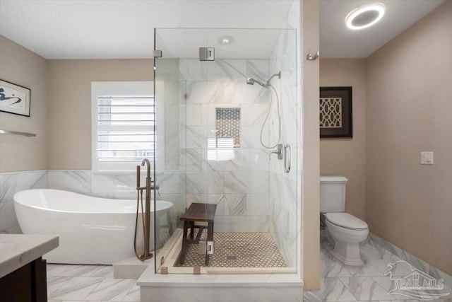 bathroom with a soaking tub, marble finish floor, and a shower stall