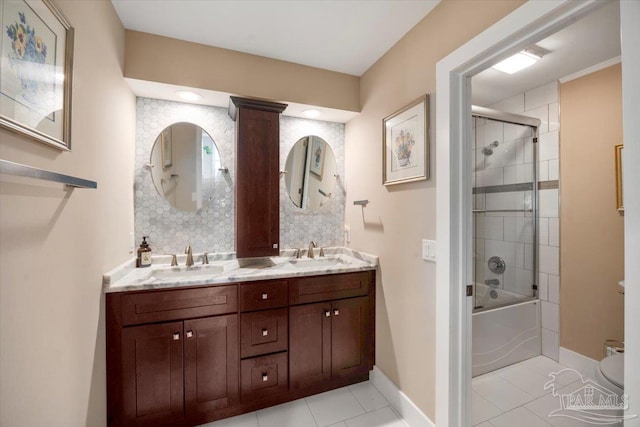 full bath featuring double vanity, baseboards, and a sink