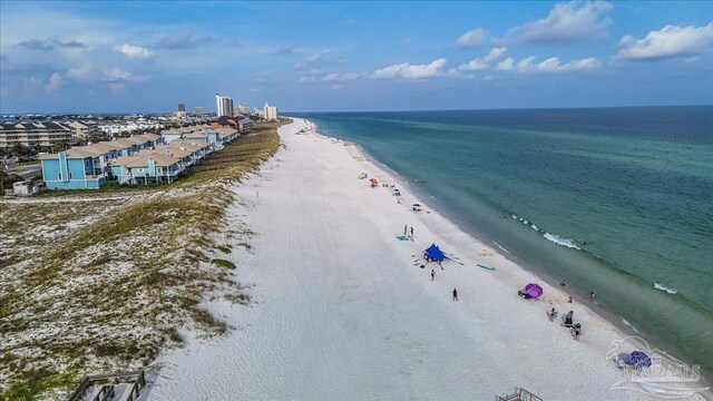 drone / aerial view featuring a water view and a view of the beach