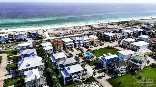 aerial view featuring a water view, a beach view, and a residential view