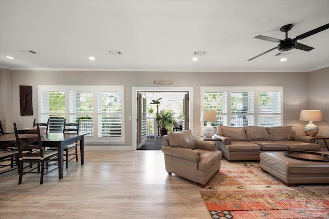 living room featuring recessed lighting, light wood-type flooring, visible vents, and crown molding