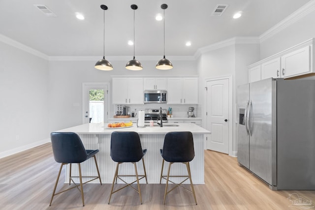 kitchen featuring stainless steel appliances, light countertops, visible vents, and ornamental molding