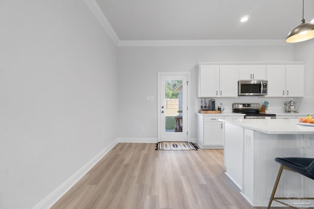 kitchen featuring white cabinets, light wood finished floors, stainless steel appliances, and light countertops